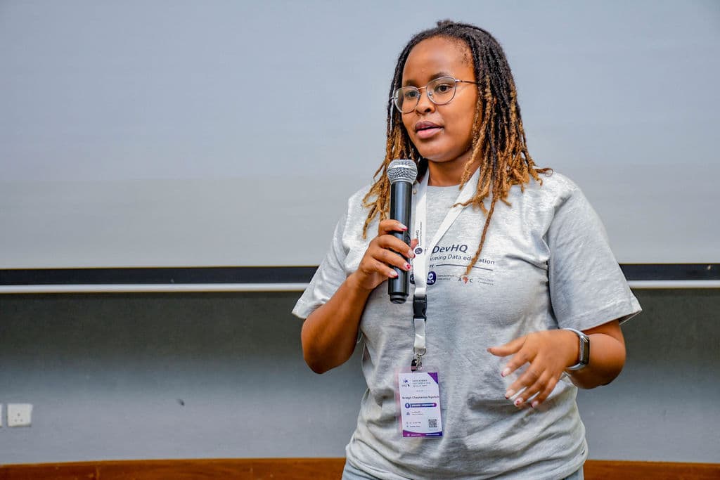 A community member speaking to the room with a microphone