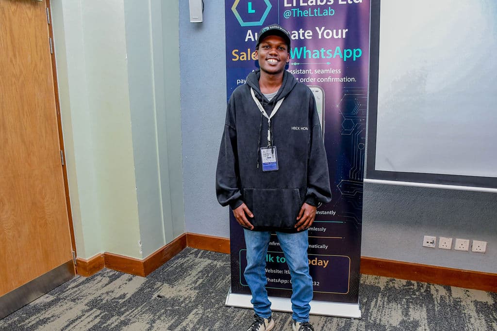 An attendee beside a partner stand between sessions