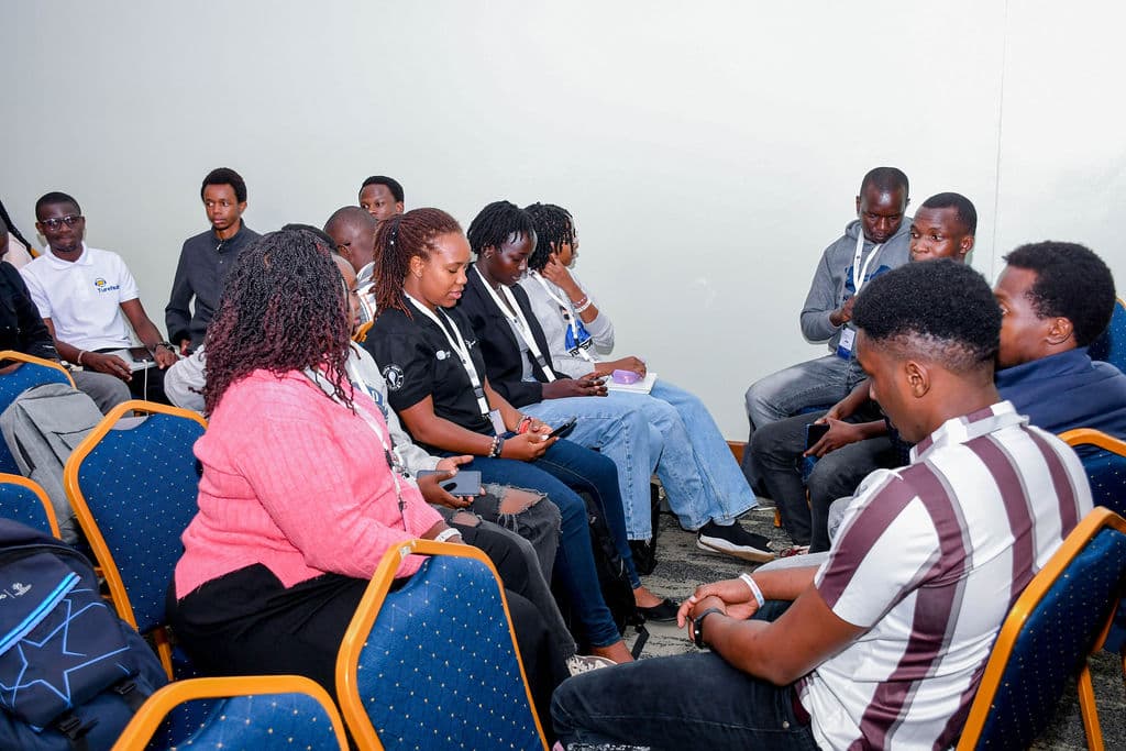 Attendees seated in a circle talking during a roundtable session